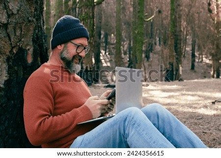 One man using technology connection in nature park forest woods. Remote worker small travel business lifestyle people. Working in the nature alternative office. Small business. Travelers job life