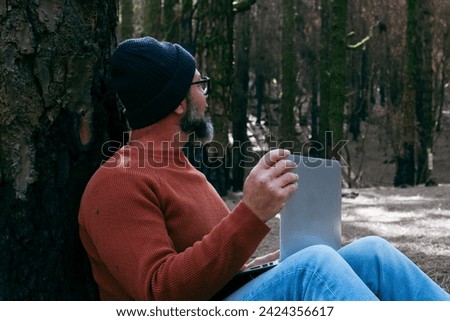 One man using technology connection in nature park forest woods. Remote worker small travel business lifestyle people. Working in the nature alternative office. Small business. Travelers job life