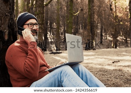 One man using technology connection in nature park forest woods. Remote worker small travel business lifestyle people. Working in the nature alternative office. Small business. Travelers job life