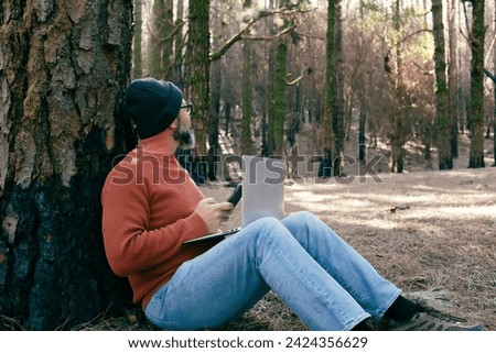 One man using technology connection in nature park forest woods. Remote worker small travel business lifestyle people. Working in the nature alternative office. Small business. Travelers job life