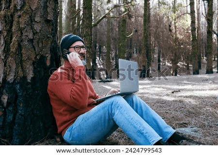 One man using technology connection in nature park forest woods. Remote worker small travel business lifestyle people. Working in the nature alternative office. Small business. Travelers job life