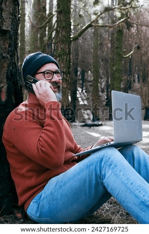 One man using technology connection in nature park forest woods. Remote worker small travel business lifestyle people. Working in the nature alternative office. Small business. Travelers job life