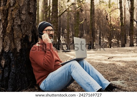 One man using technology connection in nature park forest woods. Remote worker small travel business lifestyle people. Working in the nature alternative office. Small business. Travelers job life