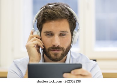 One Man Watching A Movie On Tablet Pc