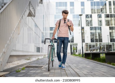 One Man Young Adult Male With Brown Hair And Mustaches Walking By The Building With Rucksack On His Back And Bicycle Happy Smile Joyful Real People Copy Space Full Length Front View