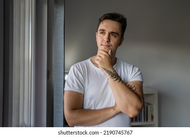 One Man Young Adult Male Caucasian With Brown Hair Standing By The Window At Home In Day Confident Looking To The Side Thinking Thoughtful Contemplation Wear White Shirt Real People Copy Space