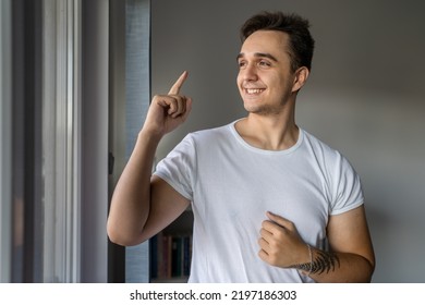 One Man Young Adult Male Caucasian With Brown Hair Standing By The Window At Home In Day Confident Looking To The Side Happy Smile Wear White Shirt Real People Copy Space Success Achievement Concept