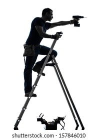 One  Manual Worker Man Standing On Ladder Drilling  In Silhouette On White Background