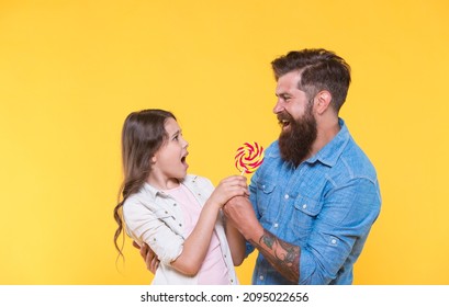 One for me none for you. Father take lollipop from unhappy child. Fighting for swirl lollipop on stick. Sweet food. Dessert snack. Candy shop. Sweetshop and confectionery. Cant wait to lick lollipop