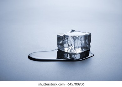 One Melted Ice Cube With Water Puddle