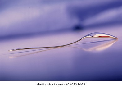 One metal teaspoon lies on the table. Cutlery. Web banner.