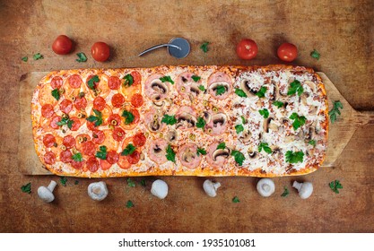One Meter Long pizza.Long pizza mix lies on a wooden table. Roman pizza on a wooden spatula. one meter long. On a wooden pizza spatula. 