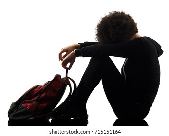 one mixed race african young teenager girl woman sadness depression in studio shadow silhouette isolated on white background