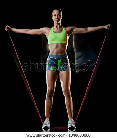 Similar – Side profile view portrait of one young athletic woman at crossfit training, exercising with trx suspension fitness straps over dark background, looking away