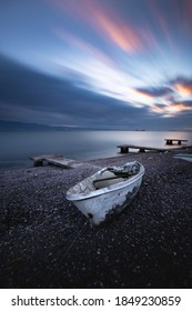 One More Day Ends With A Boat Left On The Shore And Time Passing By.