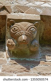 One Of The Mysterious Corbels, This One Is A Bear Eating People, Under The Eaves Of The Church Of St Mary And St David Built In The 12th Century, Kilpeck, Herefordshire, England, UK 