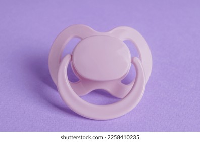One new baby pacifier on purple background, closeup - Shutterstock ID 2258410235