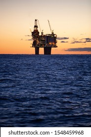 One Oil Rig In Silhouette During Sunrise In The Norwegian Oil Sector Of The North Sea