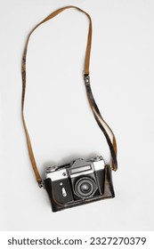 one Old, aged film camera in black leather cases isolated on white background. 1 Vintage soviet union photo camera. made in USSR.