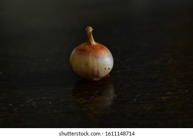 One Onion on Table with reflection