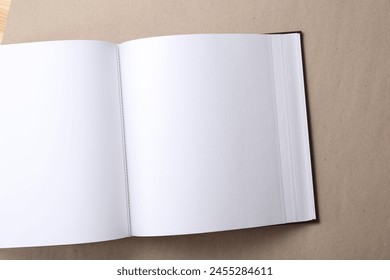 One open photo album on color background, top view. Space for text - Powered by Shutterstock