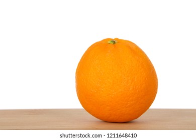 One Organic Fresh Naval Orange Laying On A Wood Table Isolated On White. 