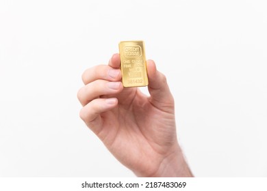 One ounce of solid gold on a white background
