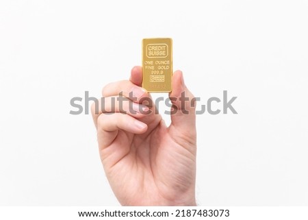 One ounce of solid gold on a white background