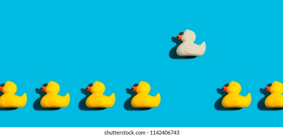 One out unique rubber duck concept on a blue background