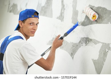 One Painter With Paint Roller Making Wall Prime Coating  At Home Repair Renovation Work