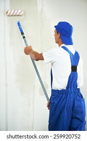 One Painter With Paint Roller Making Wall Prime Coating  At Home Repair Renovation Work