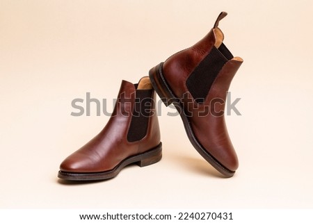 One Pair of Classic Leather Chealsea Boots As Still Life Concepts Placed Over Beige Background.Horizontal shot ストックフォト © 