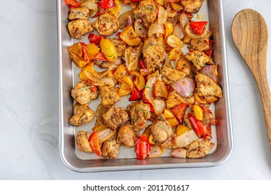 One Pan Baked Chicken And Veggies On A Baking Sheet Top Down Photo