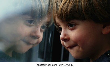 One pensive child leaning on train window. Mirror glass reflection of little boy traveling in high speed railroad train. Thoughtful kid watching landscape passing by - Powered by Shutterstock