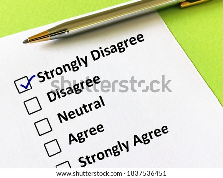 One person is answering question. The person is thinking if he is agree with the statement given. The person chooses the option of strongly disagree.