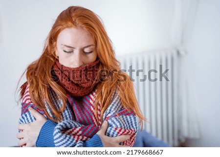 One person feeling cold at home having heating problem