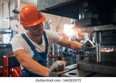 One person. Man in uniform works on the production. Industrial modern technology. - Shutterstock ID 1441831973