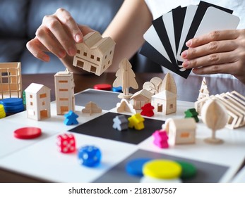 one person playing fun board game solo hobby leisure home on wooden table top selective focus