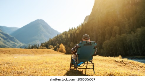 One Person Sitting In Arm Chair Outdoors