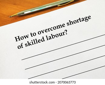 One Person Is Writing His Opinion. He Is Thinking How To Overcome  Shortage Of Skilled Labour