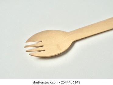 One piece of bamboo wooden kitchenware eating utensil spork. Two in one spoon fork object isolated on horizontal white background. - Powered by Shutterstock