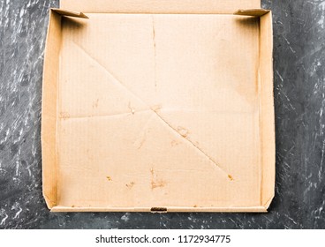 One Piece Of Pizza In Cardboard Pizza Box Top View Of Empty Box With Copy Space On Dark Concrete