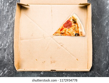 One Piece Of Pizza In Cardboard Pizza Box Top View Of Empty Box With Copy Space On Dark Concrete