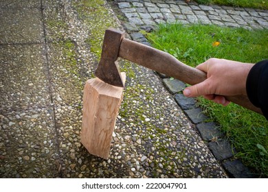 One Piece Of Wood Is Split With An Axe