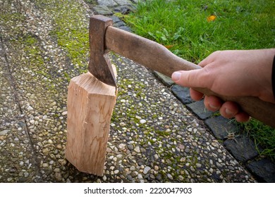 One Piece Of Wood Is Split With An Axe