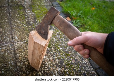 One Piece Of Wood Is Split With An Axe