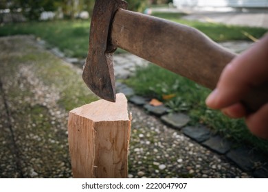 One Piece Of Wood Is Split With An Axe