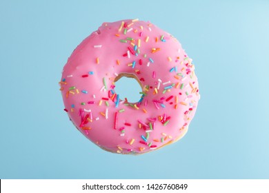 One Pink Flying Sweet Doughnut With Blue Background