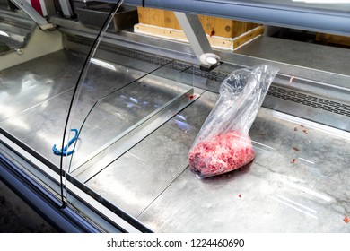 One Plastic Bag With Mince, Minced, Ground Beef Lying In Empty Refrigerated, Fridge Retail Display In Store, Butcher Shop