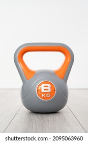 One Plastic Kettlebell Weight 8 Kg Gray And Orange Training Equipment On The Floor